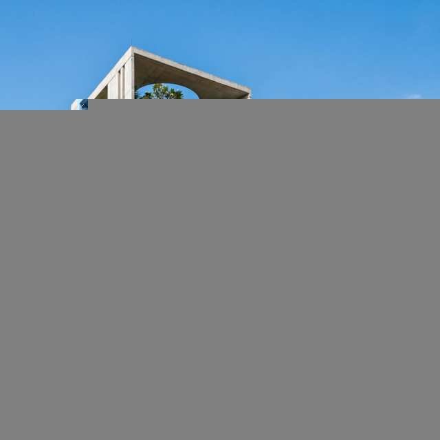 Mark D Studio residential concrete and brick building with landscaped balconies in Dhaka